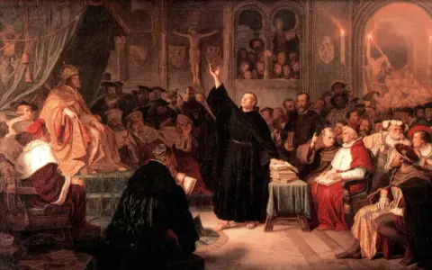 A monk preaches to a council of church leaders, including a Pope, during the Counter Reformation.