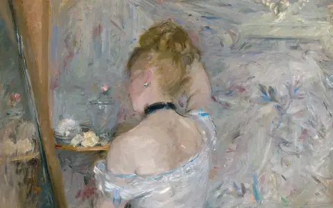 A woman with her back to the viewer, her hair in a bun, is captured in the soft, light-filled style of impressionist paintings.