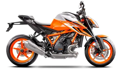 Pomarańczowo-biały motocykl KTM 1290 Super Duke R z agresywnymi grafikami i pomarańczowymi felgami.