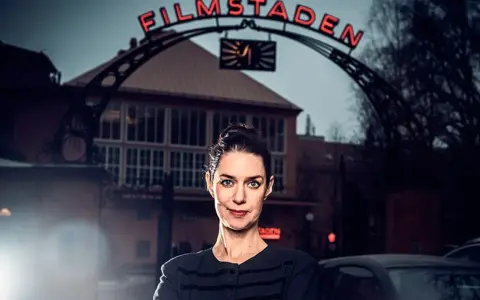 Kvinna framför Filmstaden Råsunda. En ikonisk plats för svensk filmhistoria.