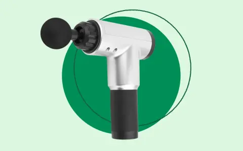 A silver and black handheld massager with a round attachment, perfect for exploring how handheld massagers work for muscle relief.