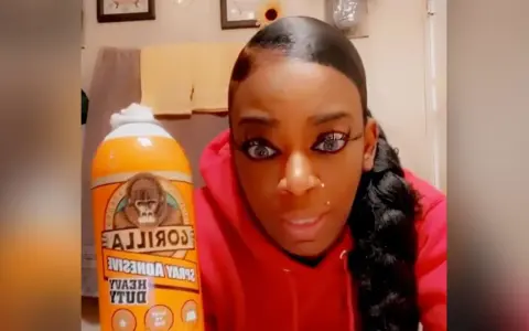 A woman holds a can of Gorilla Glue, wondering if Gorilla Glue works on plastic.