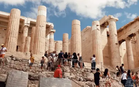 Tourists ascend the rocky path towards the Acropolis, a testament to how hard is the walk up to the Acropolis.