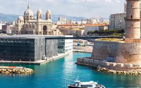 Widok na port w Marsylii z katedrą, nowoczesnym budynkiem MuCEM i wieżą Saint-Jean.