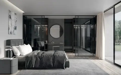 Elegante camera da letto con letto grigio scuro, abbinamenti moderni e cabina armadio a vista.