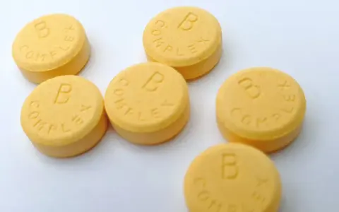 Kilka tabletek z napisem "B COMPLEX". Witamina B complex na co pomaga? Wspiera układ nerwowy i metabolizm.
