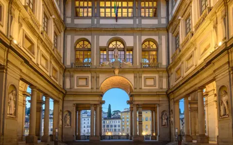The Uffizi Gallery's courtyard at dusk, with its grand architecture and statues, offers a glimpse of Florence's artistic heritage, rivaling the Accademia.
