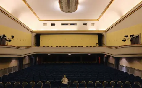 Leere Reihen im Babylon Kino Berlin. Ein Mann sitzt allein in der Mitte und wartet auf den Film.