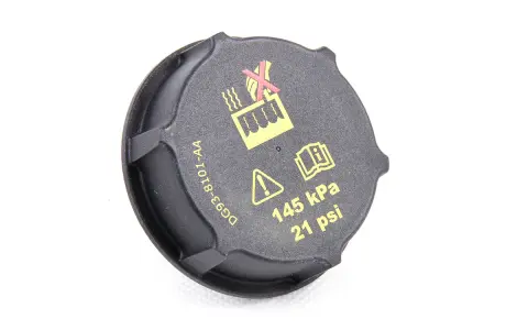 Czarne oznaczenie wlewu płynu do chłodnicy z symbolami ostrzegawczymi i informacją o ciśnieniu 145 kPa (21 psi).
