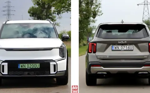 Biała Kia EV9 z przodu i szara Kia Sorento z tyłu, obie na drodze.