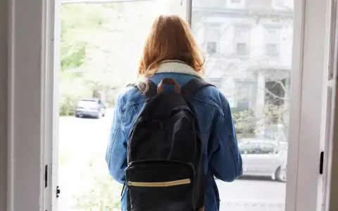 Ragazza con zaino, forse alle prese con i sintomi ADHD adulti donne, esce di casa.