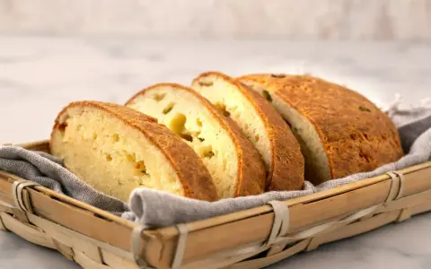 Pokrojony chleb keto przepis w koszyku. Ma złocistą skórkę i jasny, puszysty środek.