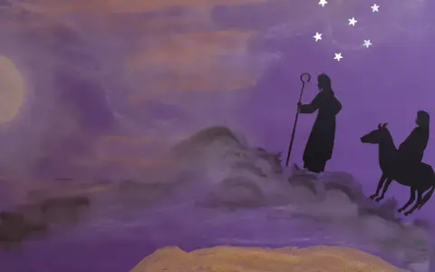Silhouettes of a shepherd and a rider on a donkey journey under a starry sky, evoking the second Sunday of Advent prayer.
