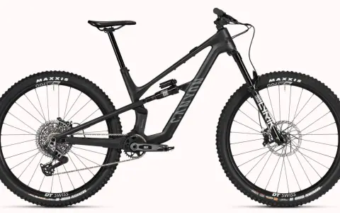 A black Canyon Spectral mountain bike, showcasing a mullet setup with a larger 29er front wheel and a smaller rear wheel, ready for any trail.