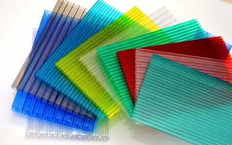 Sheets of colorful, ribbed polycarbonate, showcasing their versatility and potential for polycarbonate sustainability in various applications.