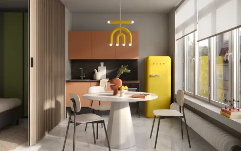 Un'elegante cucina e camera da letto insieme, con un frigorifero giallo acceso, mobili color pesca e una divisoria in legno.
