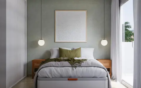 Cama moderna con cuadros decorativos que ponen en vez de cabecero. Mesitas de noche de madera y lámparas colgantes.