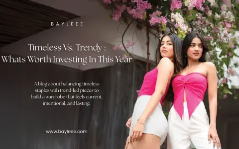 Two women showcase modern fashion couture, one in a pink tube top and white shorts, the other in a pink knotted top and white pants, against a backdrop of pink flowers.