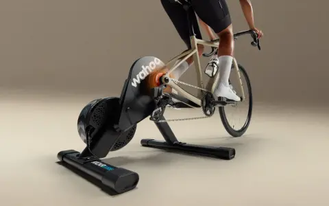 A cyclist rides indoors on a Wahoo Kickr Core 2 trainer, simulating an outdoor ride with realistic resistance.