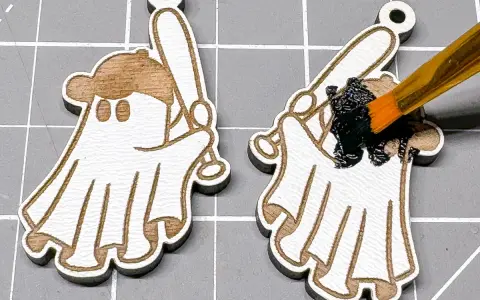 Painting a laser-engraved ghost with a baseball bat black. This shows how to color laser engraving for a spooky effect.