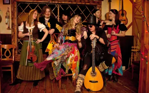 Ritchie Blackmore heute mit seiner Band Blackmore's Night in mittelalterlicher Kleidung, umgeben von Instrumenten.