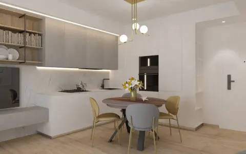 Ingresso su sala da pranzo con tavolo rotondo, sedie, cucina moderna e scaffali a muro.