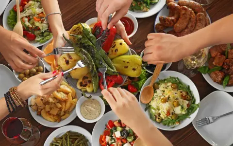 Un repas convivial avec des spécialités du Luberon : légumes grillés, saucisses, pommes de terre et salades.