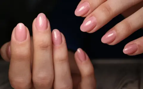 Delikatne, różowe paznokcie hybrydowe z subtelnym blaskiem. Idealna baza do stylizacji, która podkreśla naturalne piękno dłoni.