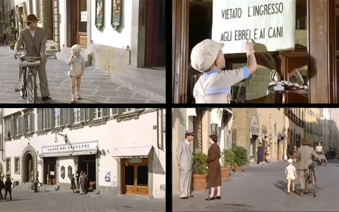 Scena di film girati ad Arezzo: un bambino legge un cartello "Vietato l'ingresso agli ebrei e ai cani", un padre e figlio passeggiano, un caffè storico e una strada con persone.
