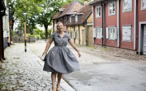 Kvinna i rutig klänning på kullerstensgata, inspirerad av Elsa Billgrens blogg.