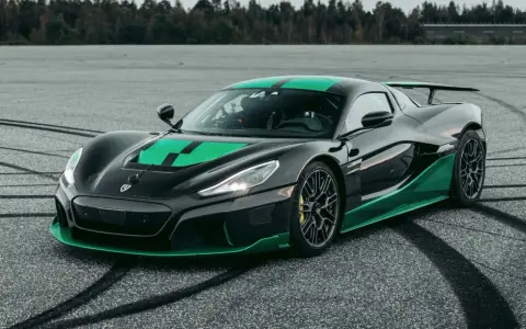 Czarny hipersamochód Rimac Nevera z zielonymi akcentami na torze.