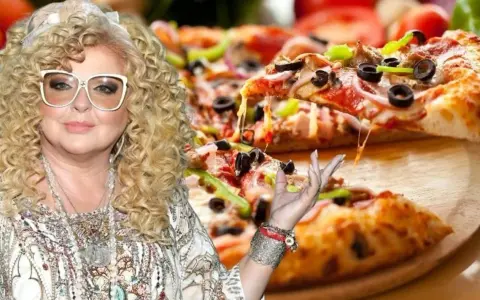 Magda Gessler prezentuje pyszną pizzę z ciągnącym się serem.