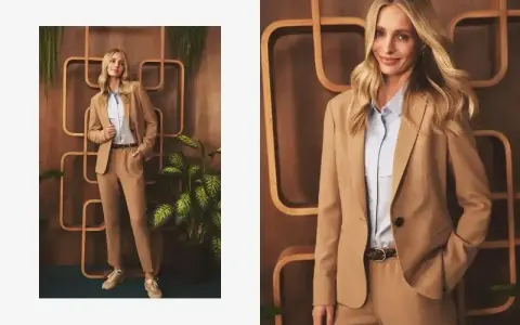 Elegancka stylizacja: jakie spodnie do jasnej marynarki? Modelka prezentuje beżowy garnitur z błękitną koszulą i sneakersami.