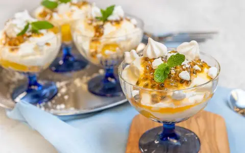 Fluffig Eton Mess med passionsfrukt och maräng i glasbägare. En härlig dessert som smälter i munnen.