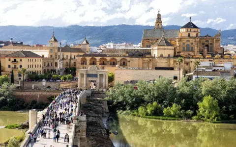 A bustling Roman bridge leads to the historic Mezquita-Cathedral of Córdoba. This view makes you wonder how many days in Córdoba are enough to explore its wonders.