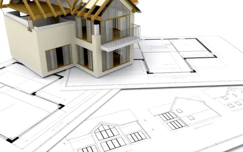 Model domu na planach architektonicznych. Zastanawiasz się, ile trwa budowa domu? To zależy od wielu czynników.