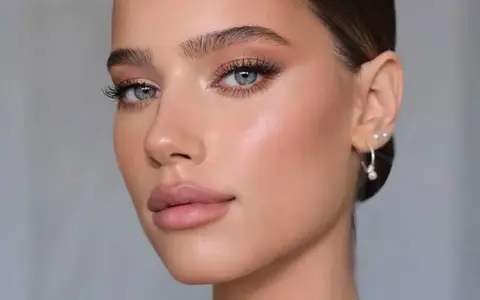 Volto femminile con trucco cerimonia impeccabile: occhi luminosi, labbra nude e pelle radiosa. Perfetto per un evento speciale.