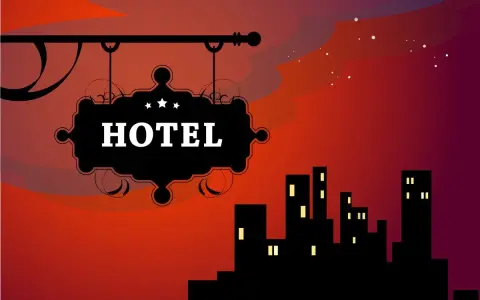 Czarny szyld hotelowy z napisem "HOTEL" na tle nocnego miasta i czerwonego nieba.