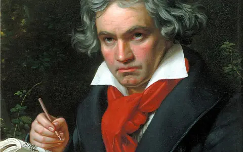 Portret Beethovena, geniusza muzyki, pochylonego nad nutami. Jego wzrok pełen pasji, a dłoń z ołówkiem gotowa do tworzenia.