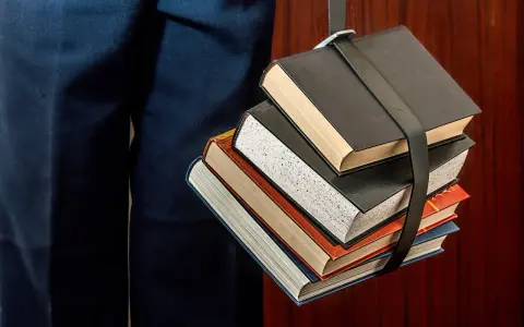 Un fascio di libri legati da una cinghia, un simbolo del percorso per capire come funzionano i CFU e il carico di studio.