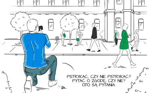 Fotograf klęczy, by zrobić zdjęcie. Zastanawia się, czy pytać o zgodę, jak w umowie rodo dla fotografa.