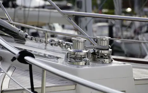 Deux winches chromés sur un bateau, prêts à hisser la chaîne de l'ancre. Le schema guindeau est bien visible.