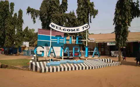 Välkommen till The Gambia! En skylt välkomnar besökare, kanske på väg för att få sitt vaccin.