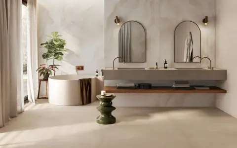 Baño moderno con bañera exenta, lavabos dobles y azulejos a matajunta en paredes y suelo.