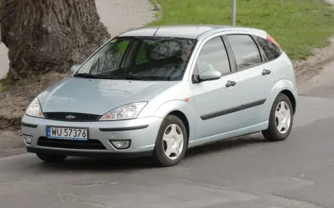 Srebrny Ford Focus, idealny dla szukających tanich samochodów do 3000 zł, jedzie po drodze.