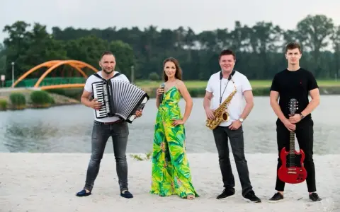 Teraz my - zespół skład: akordeonista, wokalistka, saksofonista i gitarzysta pozują na plaży.