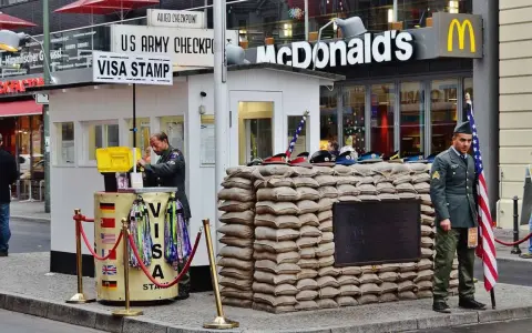 Checkpoint Charlie, ett måste att se i Berlin, med soldater och en McDonald's i bakgrunden.