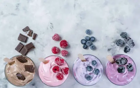 Vier Gläser mit leckerem Nicecream: Schoko, Himbeer, Blaubeer und Brombeer. Perfekt für heiße Tage!