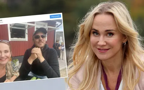 Anja Lundqvist med sin partner framför en röd byggnad.