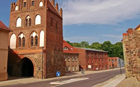 Historisches Stadttor in Templin Altstadt, mit Backstein und Feldstein erbaut, daneben rote Backsteingebäude und eine Steinmauer.